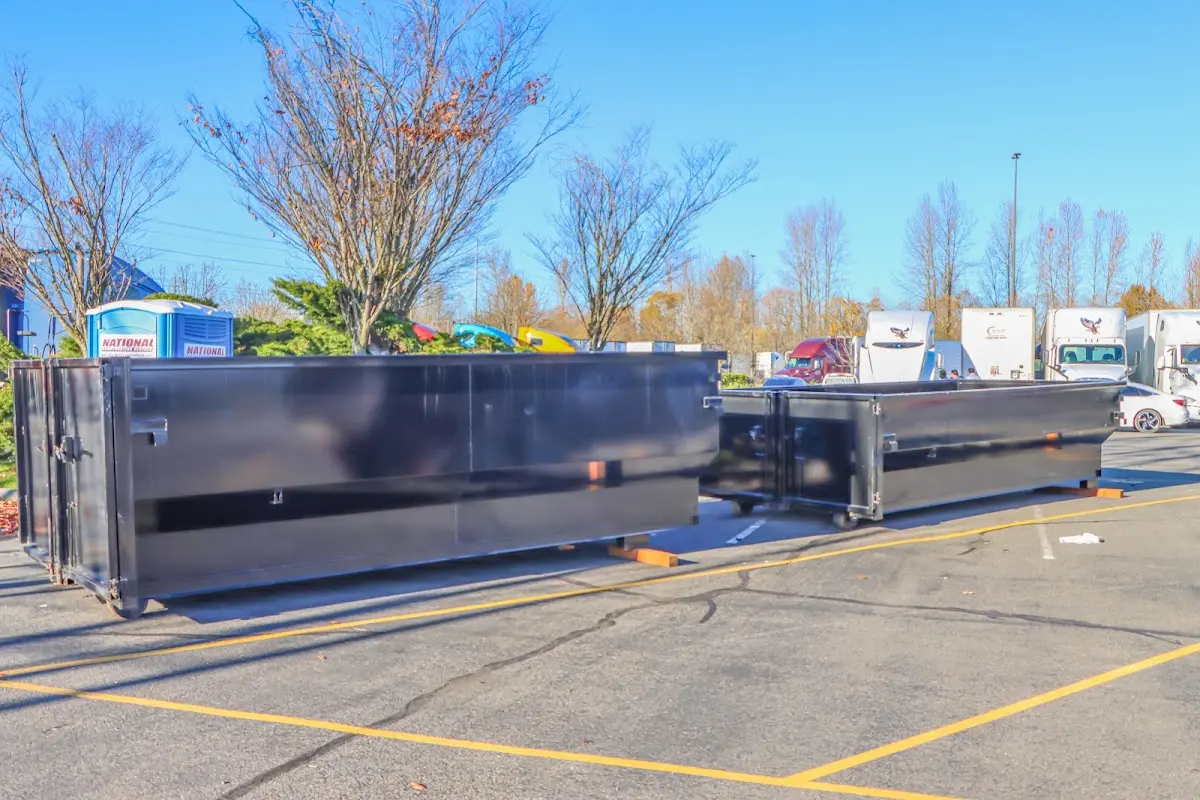 Professional dumpster rental service with roll-off container on residential driveway in Garnet